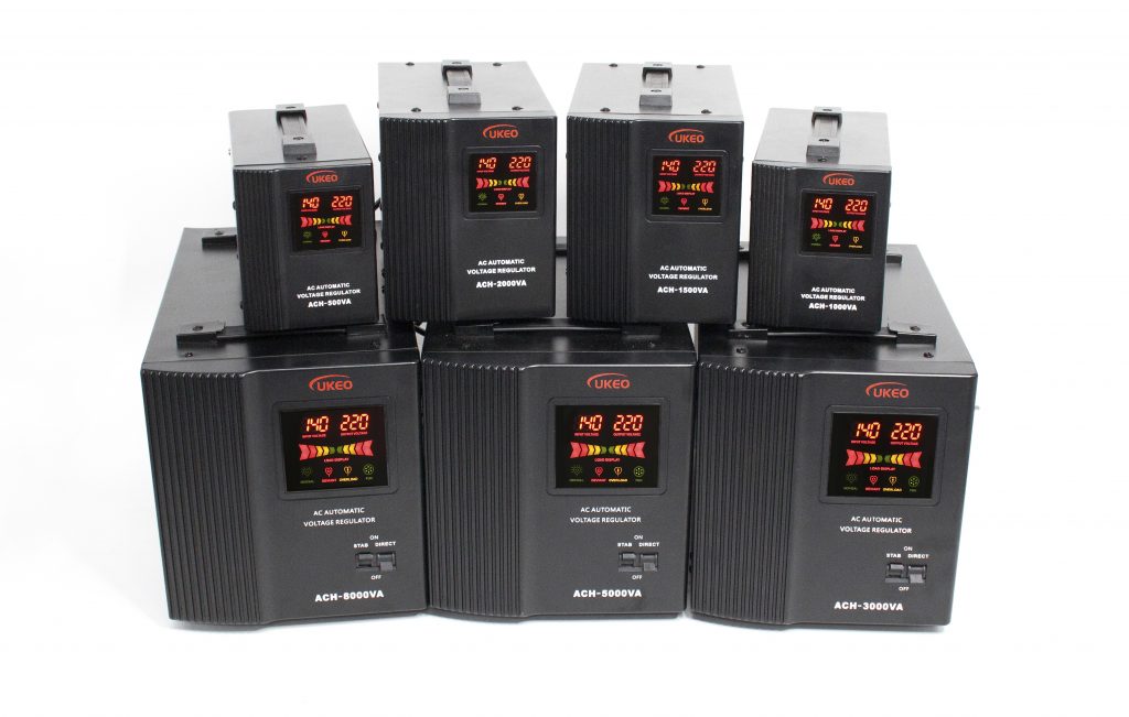A group of small black Voltage stabilizers with vertical stripes